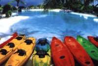 Colorful kayaks by the lagoon.